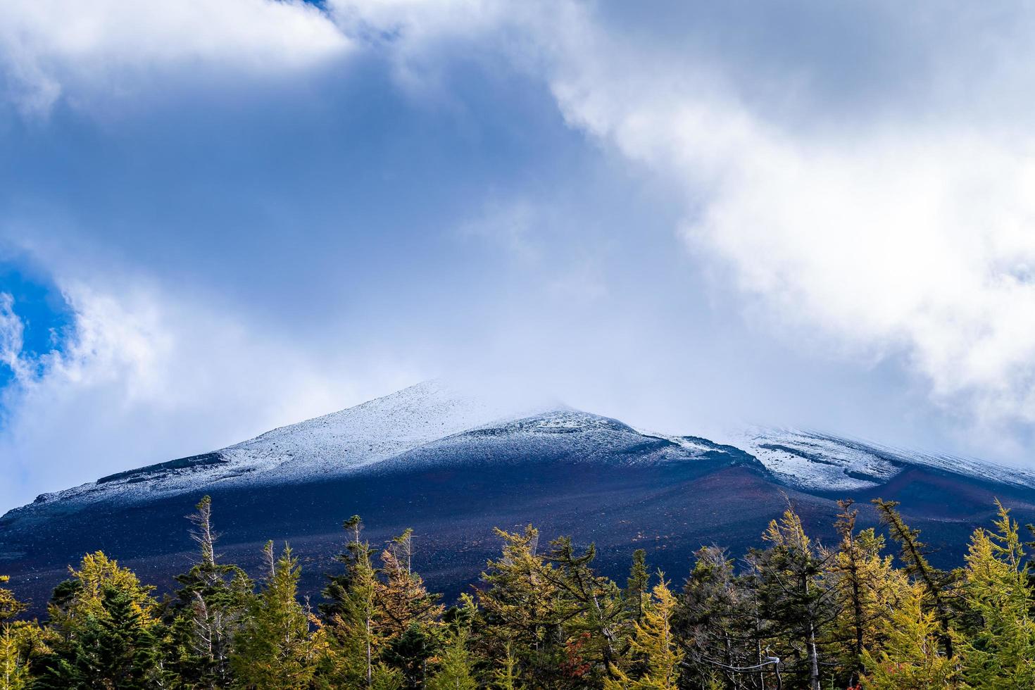 Close up top of Fuji mountain with snow cover and wind on the top with could in Japan. photo