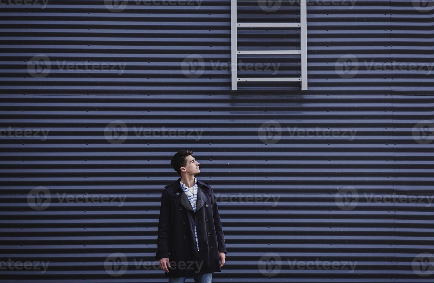 Young millennial man dressed in coat photo
