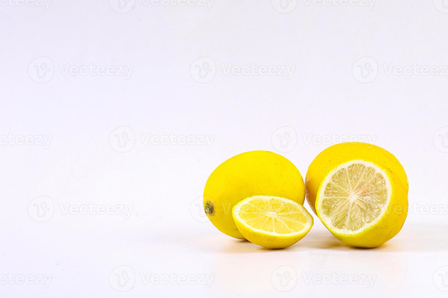 Fresh lemon with slices isolated on white background photo