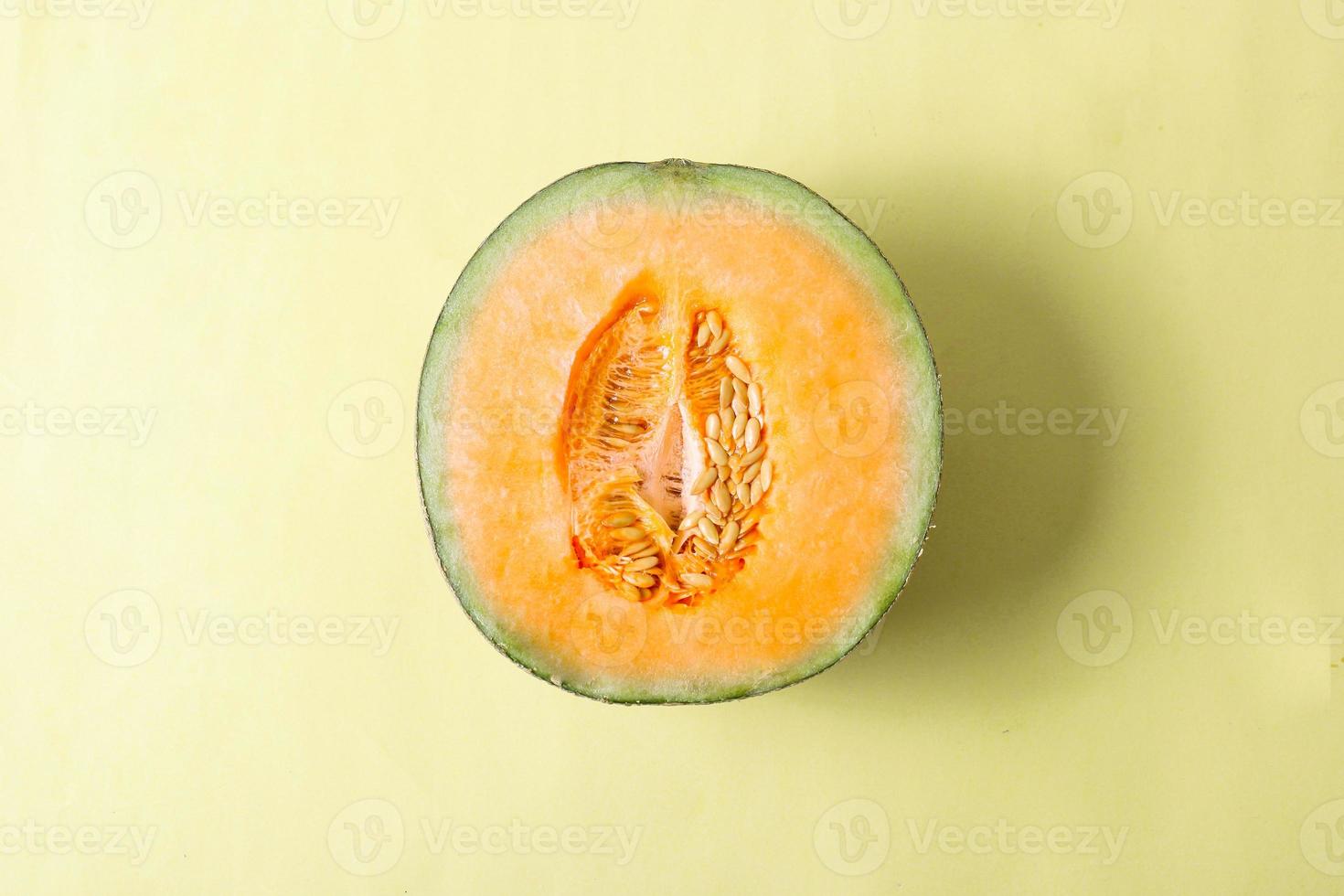 Top view of yellow melon slice on yellow background photo
