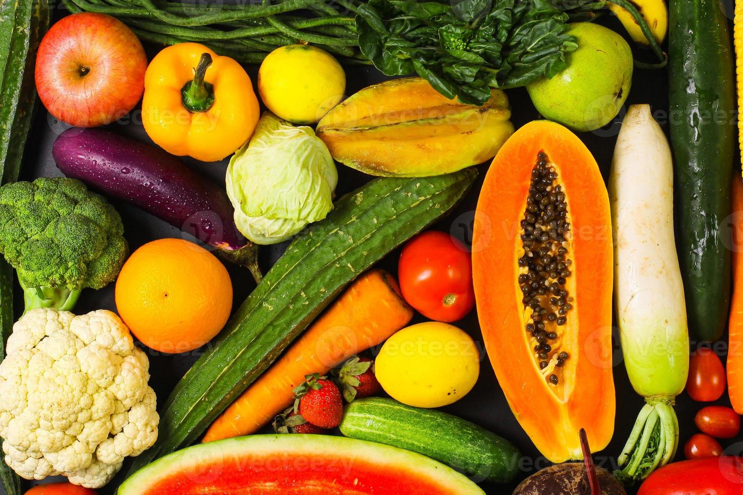 Healthy food background of assorted fresh fruits and vegetables in creative flat lay composition photo