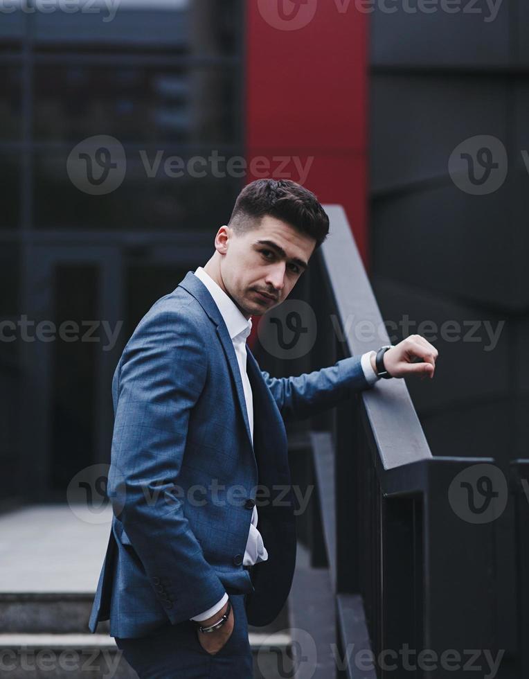 Confident man in suit standing outdoors photo