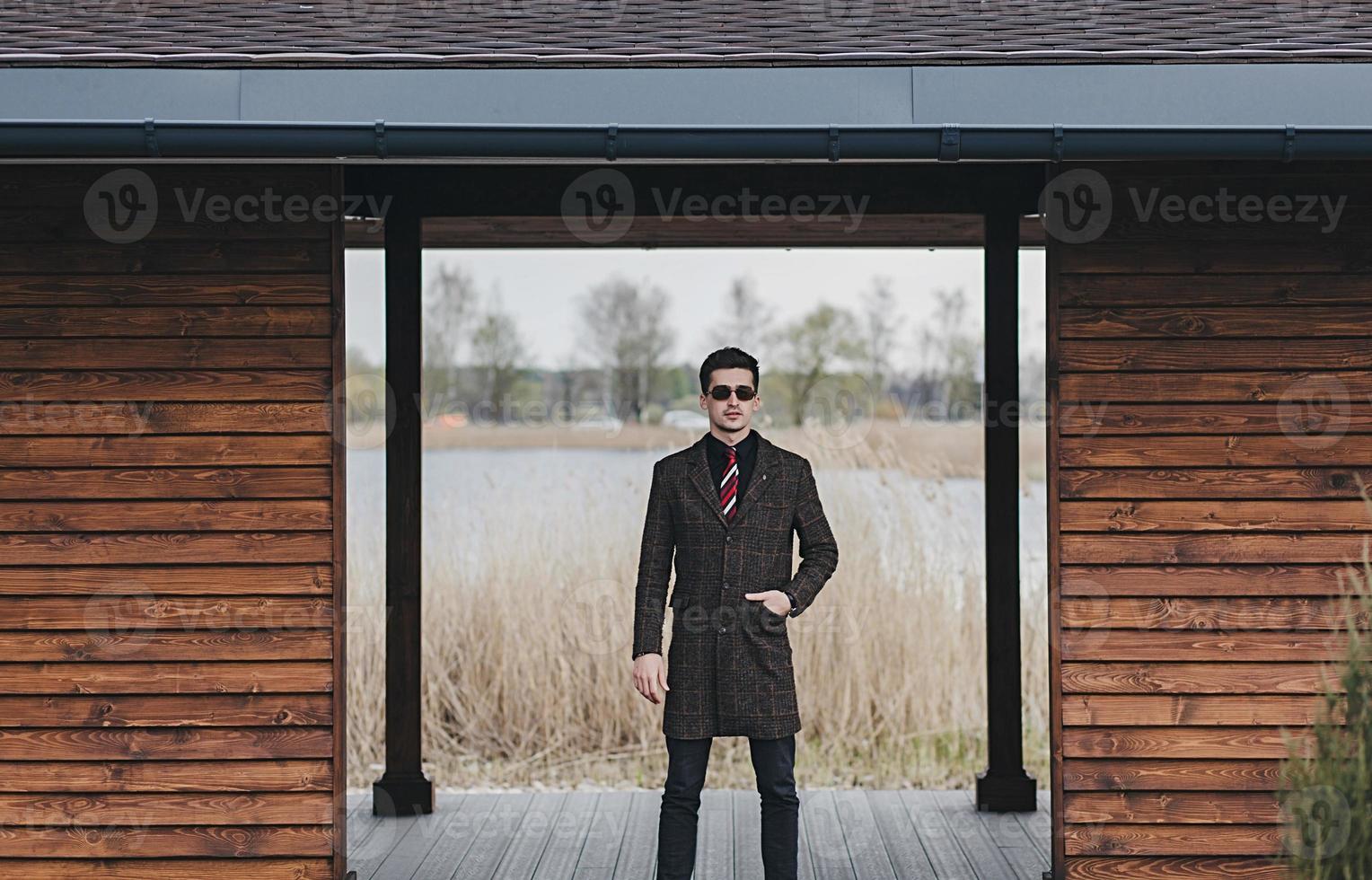 man in coat and sunglasses photo