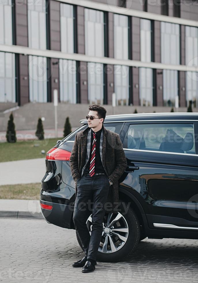 businessman standing near the car photo