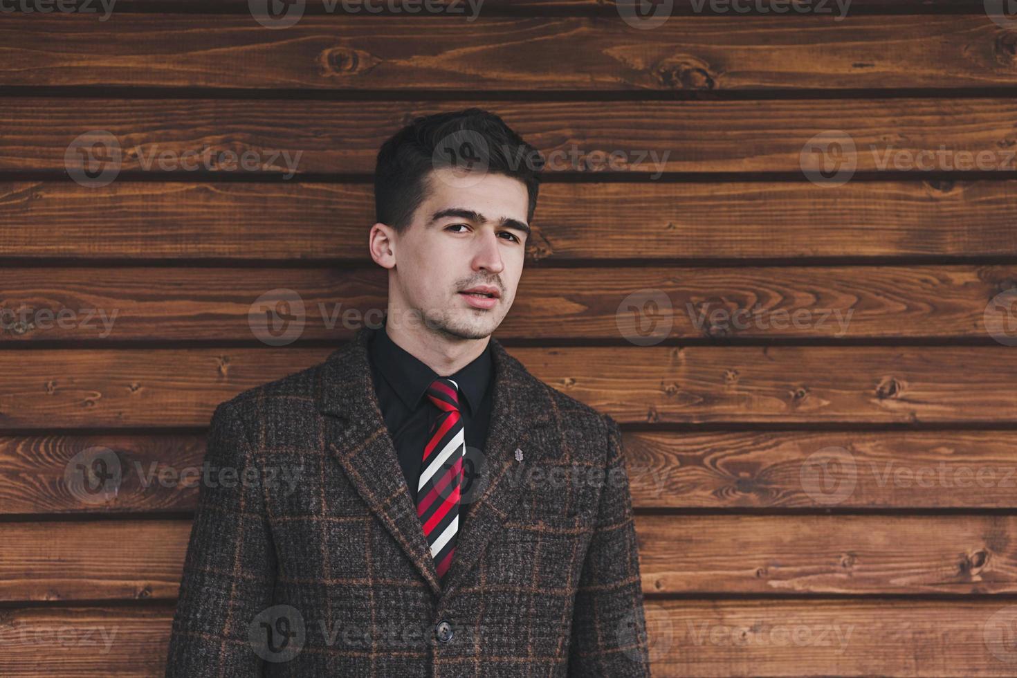 Stylish young man in coat and tie photo