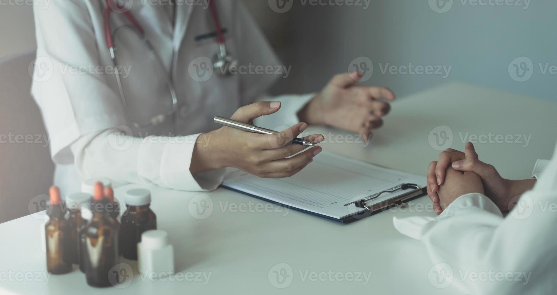 doctor holding test results and consulting patient at desk medical office, Hospital clinic healthcare professionalism concept photo