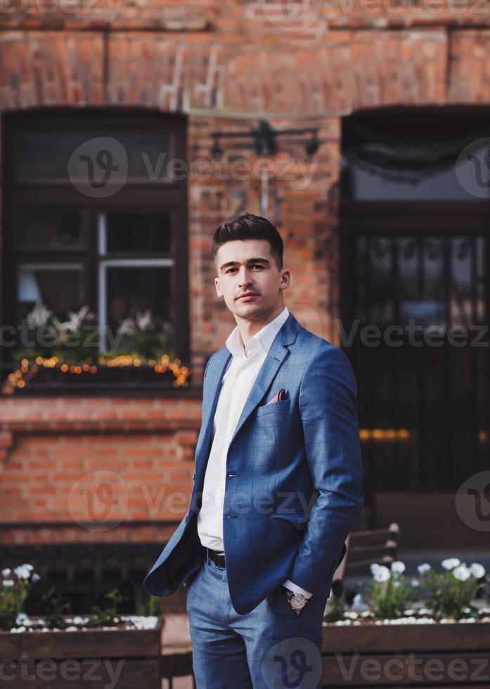 Handsome young brunette model, wearing suit photo