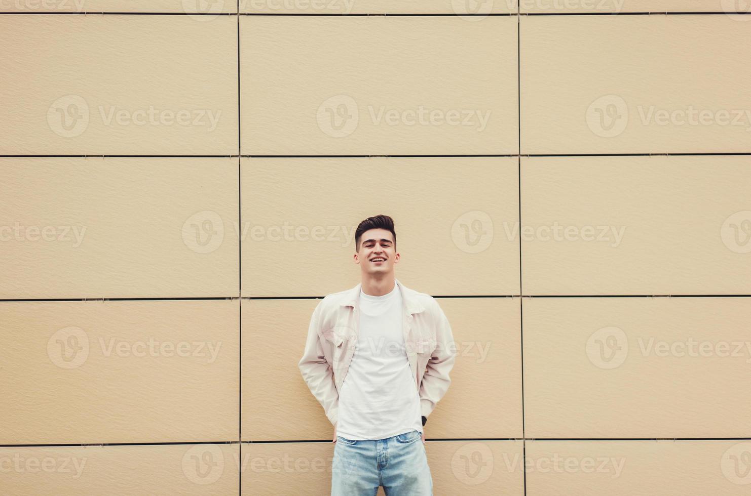 Handsome young smiling man looking at camera photo