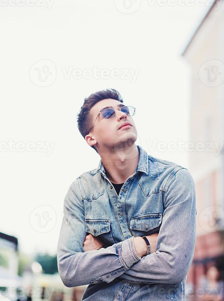 Handsome young man in sunglasses photo