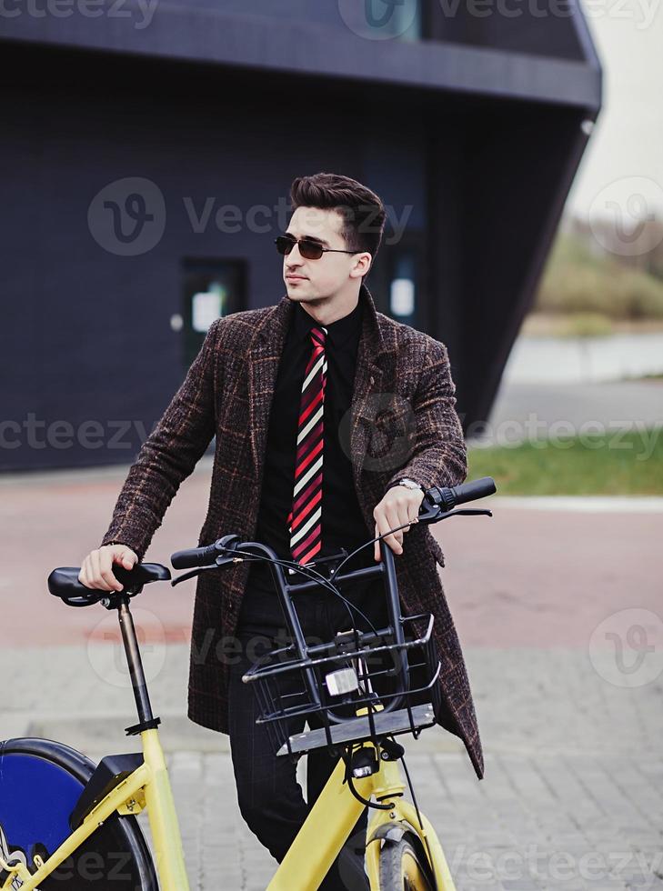 successful man with bicycle photo