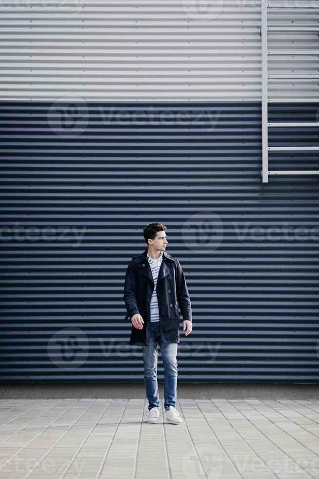 Fashionable young man in jeans photo