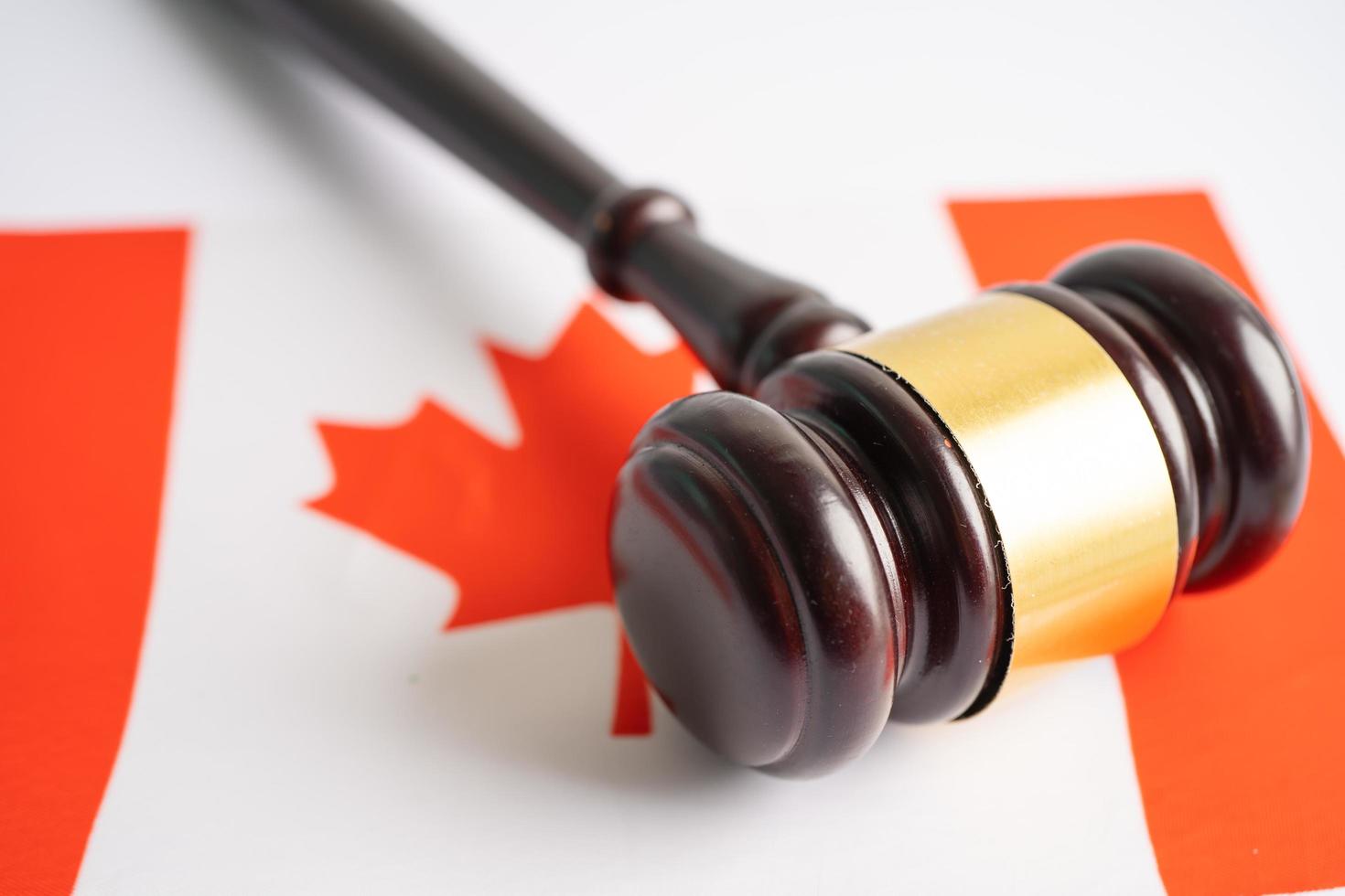 Canada flag with gavel for judge lawyer. Law and justice court concept. photo