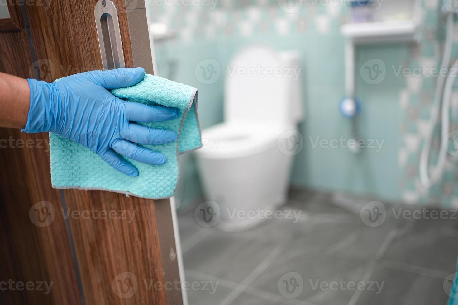 Cleaning door toliet handle at toilet with alcohol and soft cloth at office and home for protect covid 19 coronavirus photo