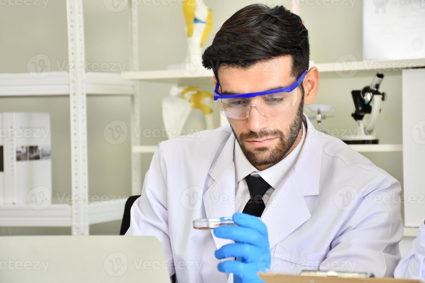 Scientists show test tubes that are satisfactory. Scientists have successfully discovered a cure for viral disease. photo