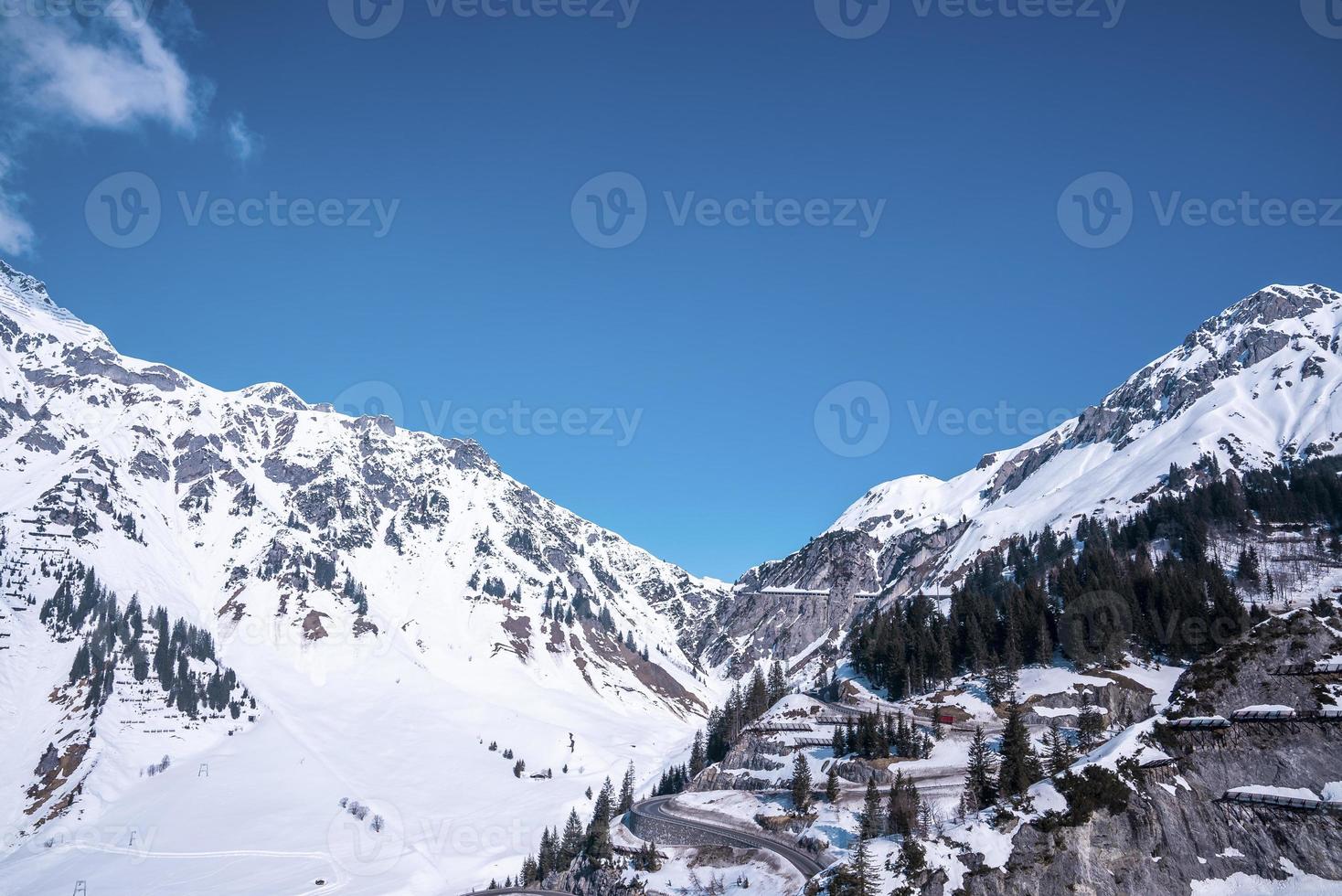 Avalanche barriers on snow covered mountain slope with trees photo