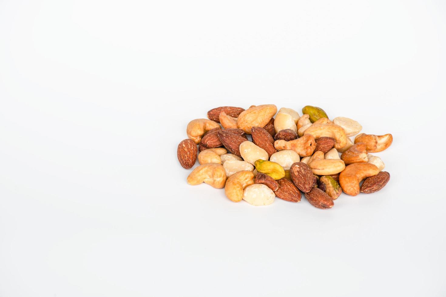 Concept, trail mix day. trail mix placed on a white floor table. Closeup. copy space on left for design or text. White background. photo