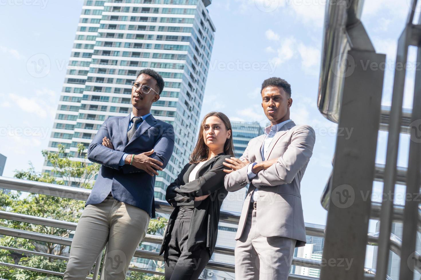 Group of business people.Business people meeting talking and sharing their ideas in city. Business team and teamwork concept. Business people standing outside in the city discussing about new project. photo