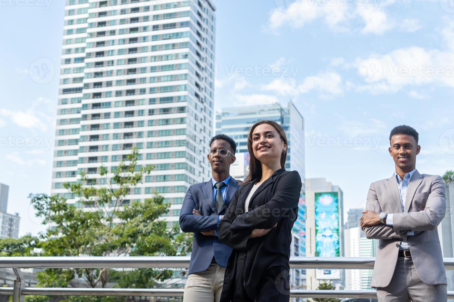 Group of business people.Business people meeting talking and sharing their ideas in city. Business team and teamwork concept. Business people standing outside in the city discussing about new project. photo