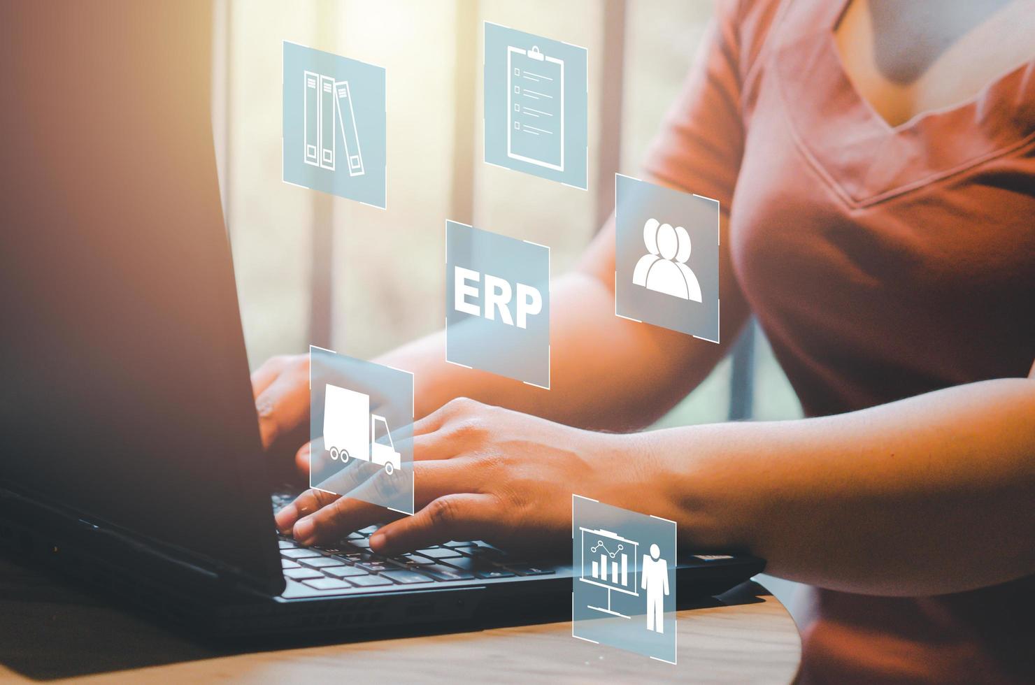 Enterprise Resource Planning ERP document management concept icons on virtual screen.hands typing on computer laptop as background photo