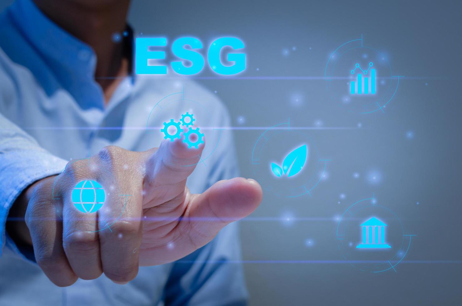 Environmental social and governance ESG investment Organizational growth that is sustainable is a business idea.  man's on icon  ESG word on hand a virtual screen. photo
