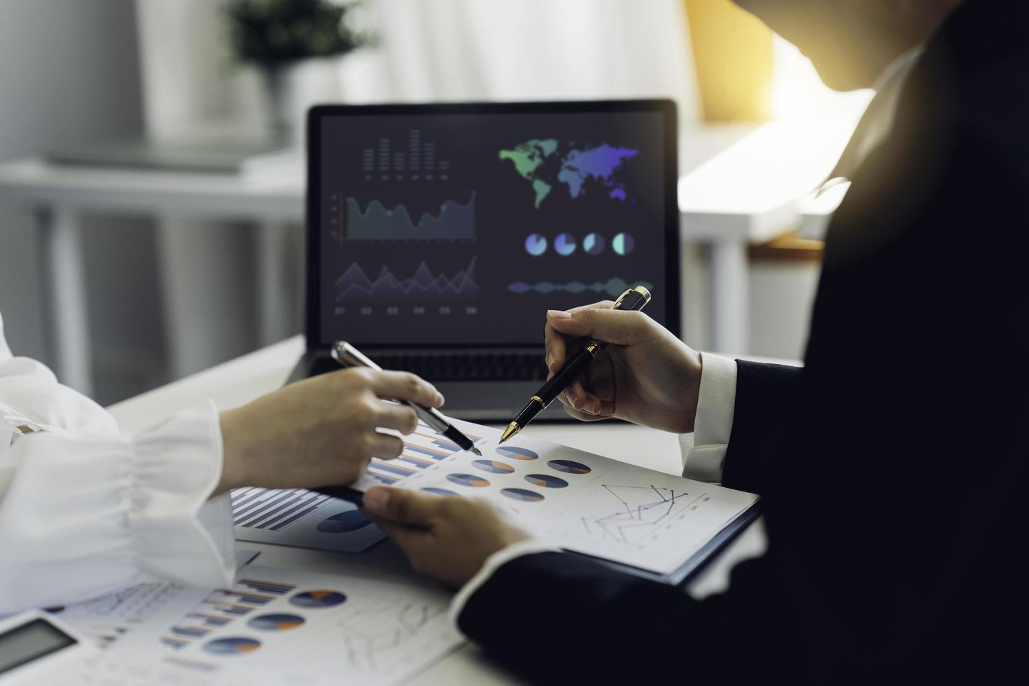 Business team meeting present, investor colleagues discussing new plan financial graph data on office table with laptop, Finance, accounting, investment. photo