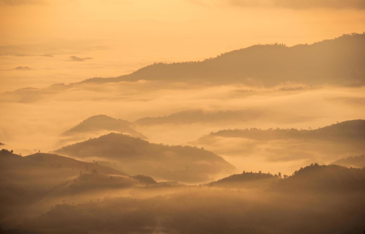 The fog covered the mountains range in Chiang Rai the province in northern region of Thailand in winter season. photo