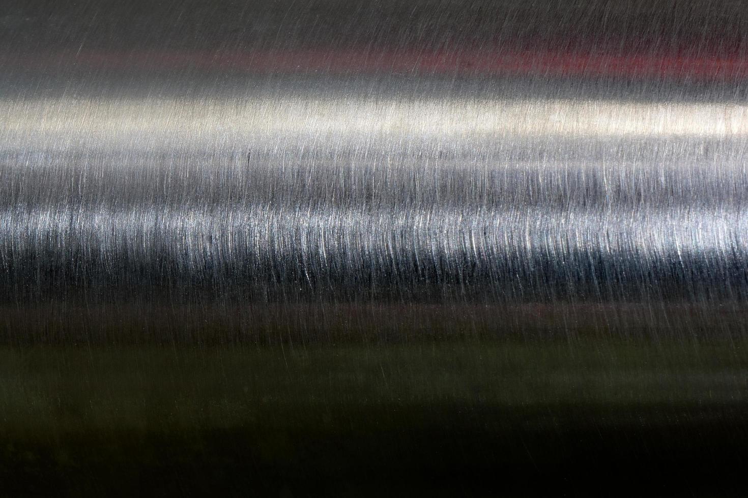 Texture of reflection on stainless steel pipe in dark room, abstract background photo