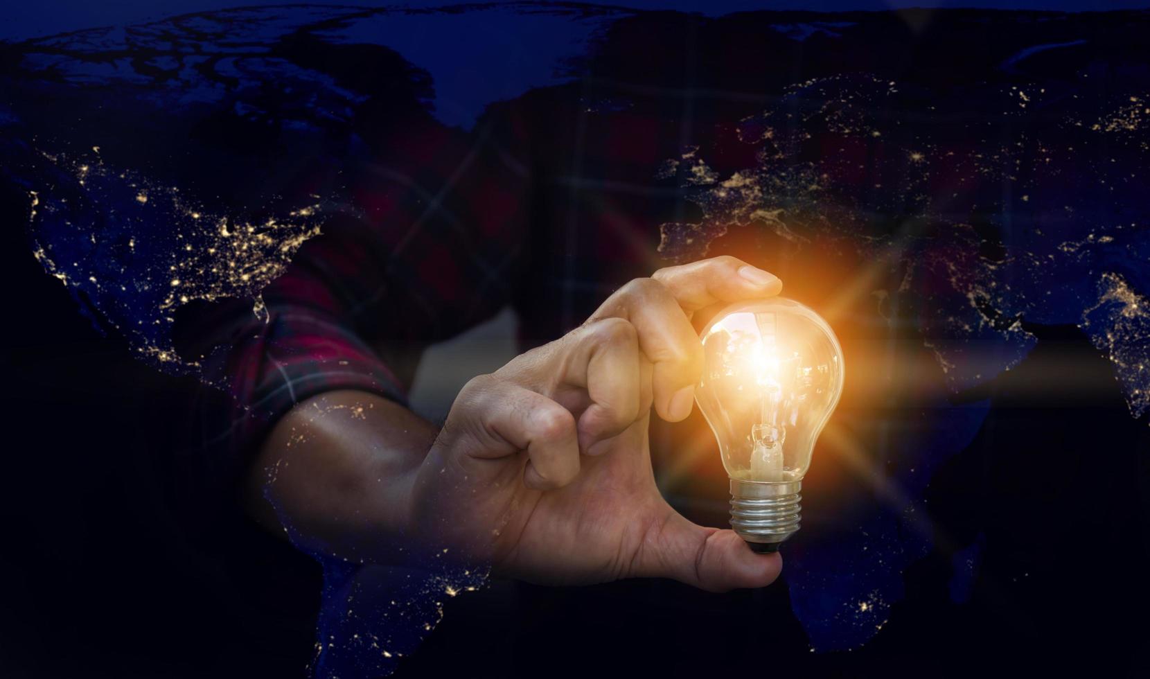 Light bulb in hand, Idea concepts. Man hand holding light bulb blurred background. photo
