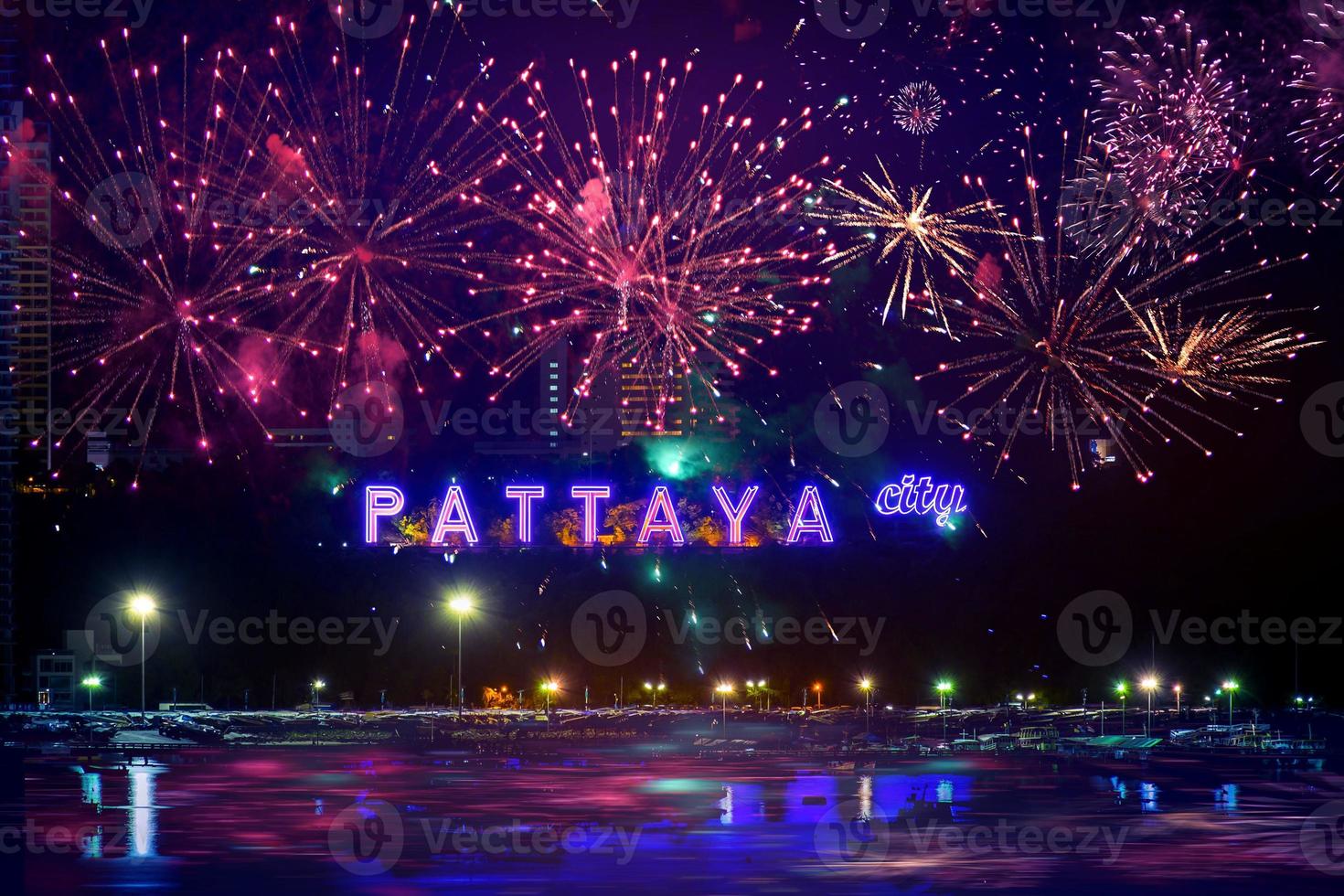 Colorful fireworks on Pattaya city alphabet in the night scene photo