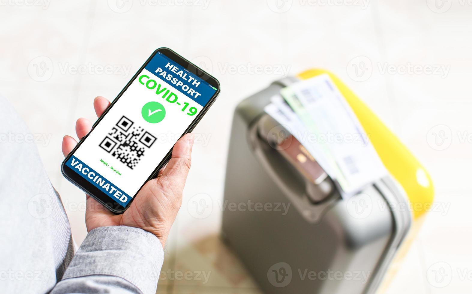 Tourists holding a smartphone to show vaccine passport vaccination against coronavirus or COVID-19. The concept for preventing the spread of coronavirus. and safety demonstrations after vaccination. photo