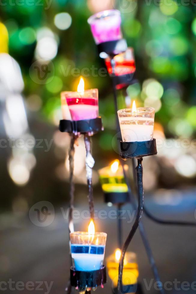 The candle is lit in a glass with a blurred background. 6991251 Stock