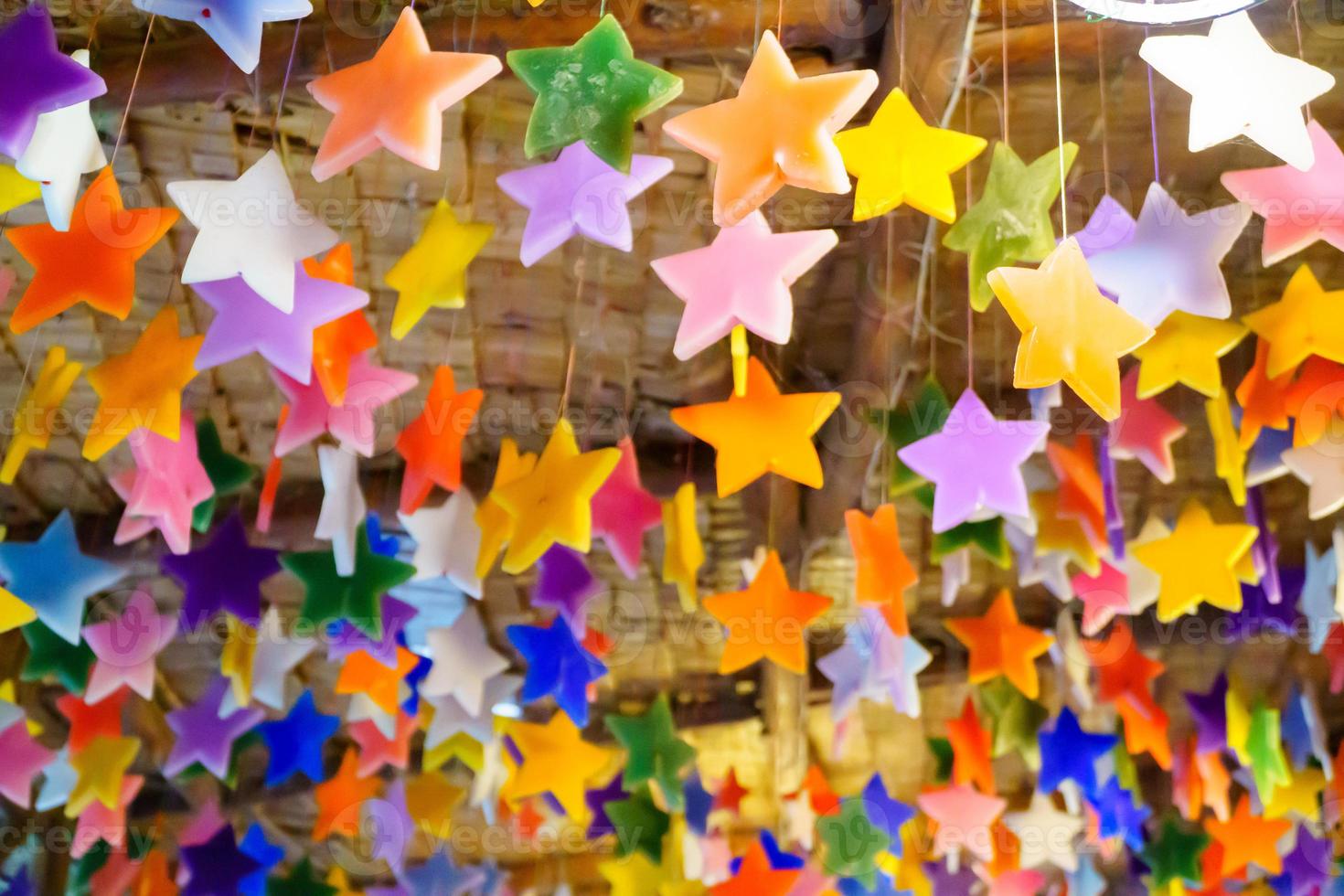 Multicolored candles cast in the shape of a star. photo
