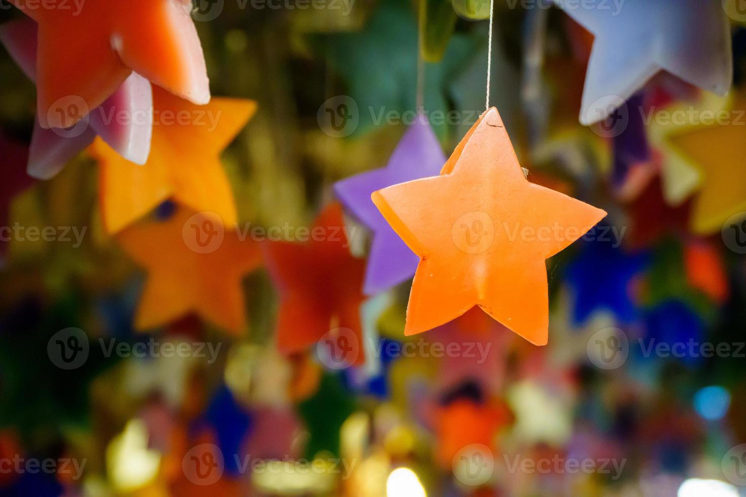 Multicolored candles cast in the shape of a star. photo