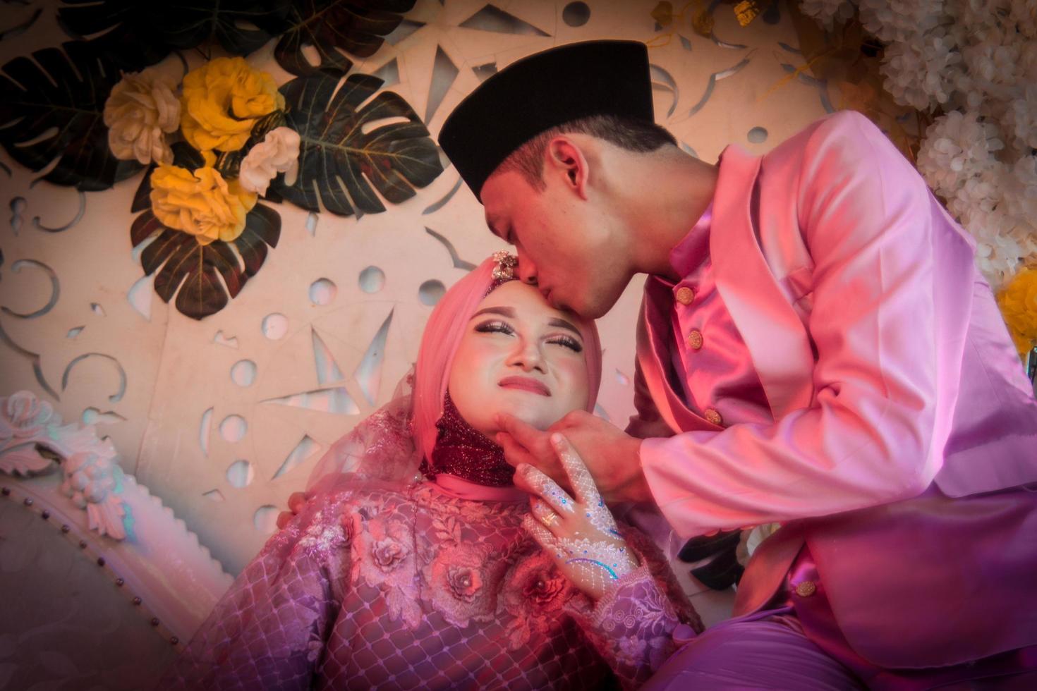 Cianjur Regency, West Java, Indonesia on June 12, 2021, A pair of lovers stare at each other about to kiss. photo