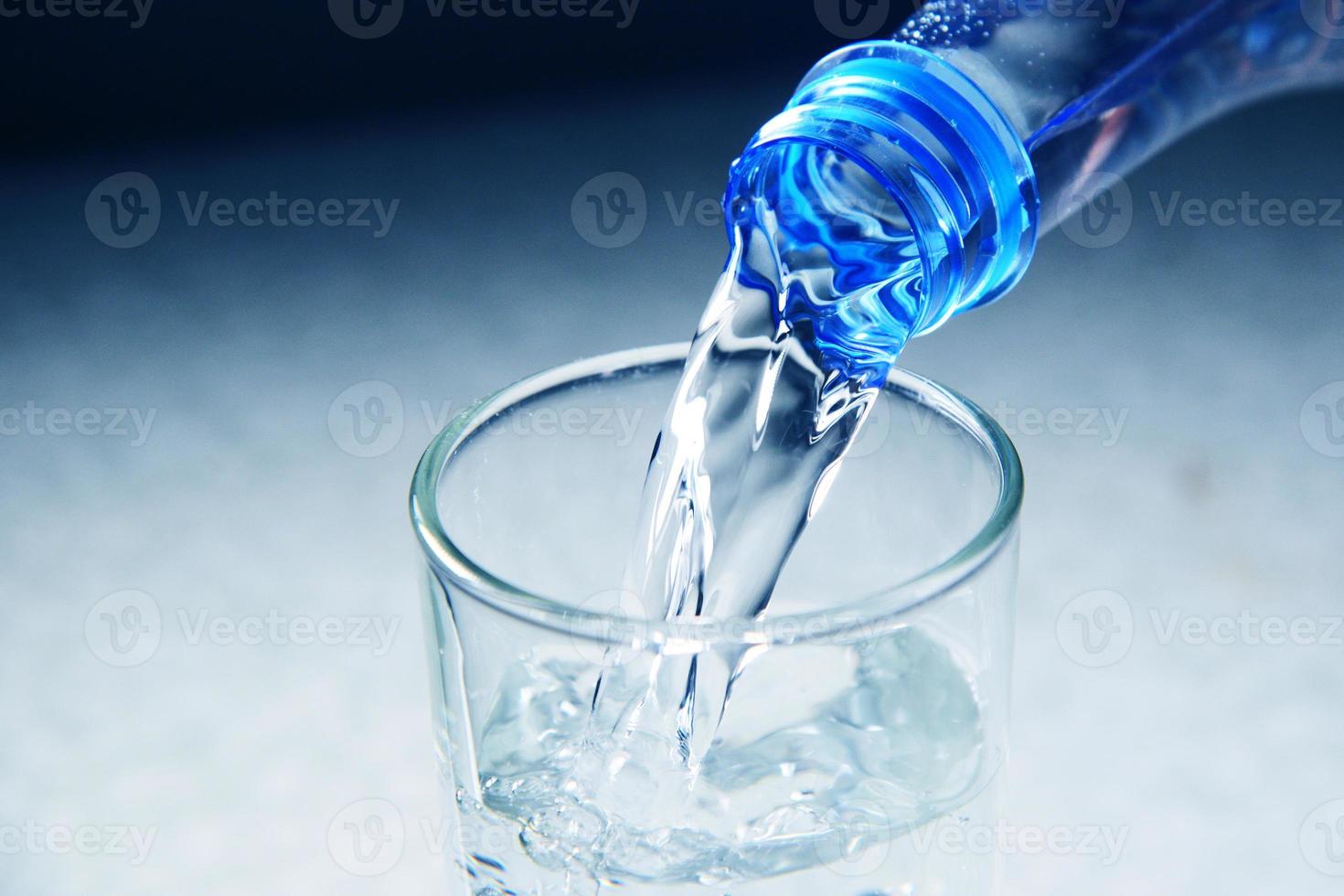 glass is filling splashing water collection on white background photo