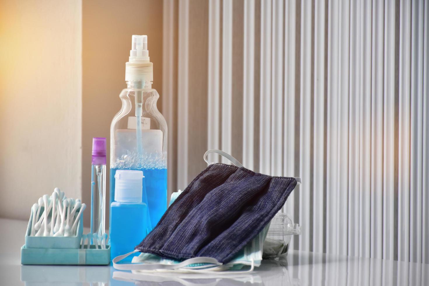 Hand sanitizer gel and facemasks to clean hands and wear before getting inside to protect and prevent Covid-19 virus or Coronavirus and germs. photo