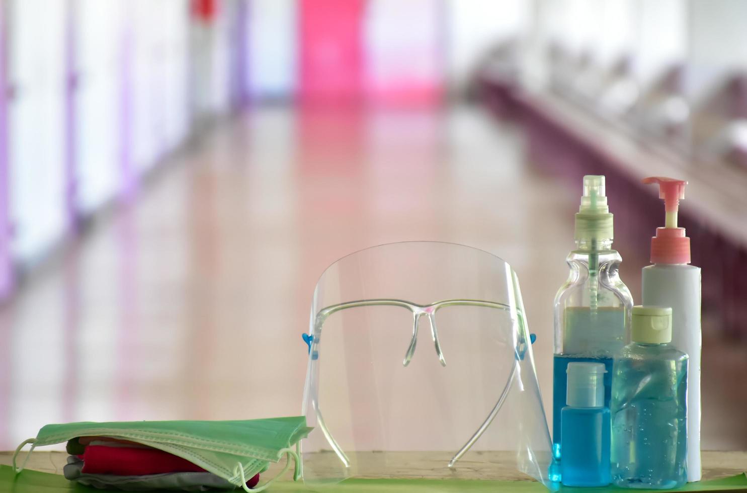 Hand sanitizer gel and facemasks to clean hands and wear before getting inside to protect and prevent Covid-19 virus or Coronavirus and germs. photo