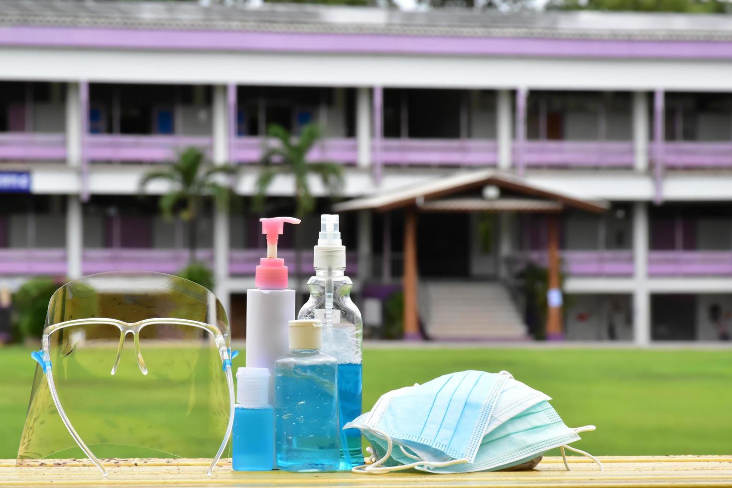 Hand sanitizer gel and facemasks to clean hands and wear before getting inside to protect and prevent Covid-19 virus or Coronavirus and germs. photo