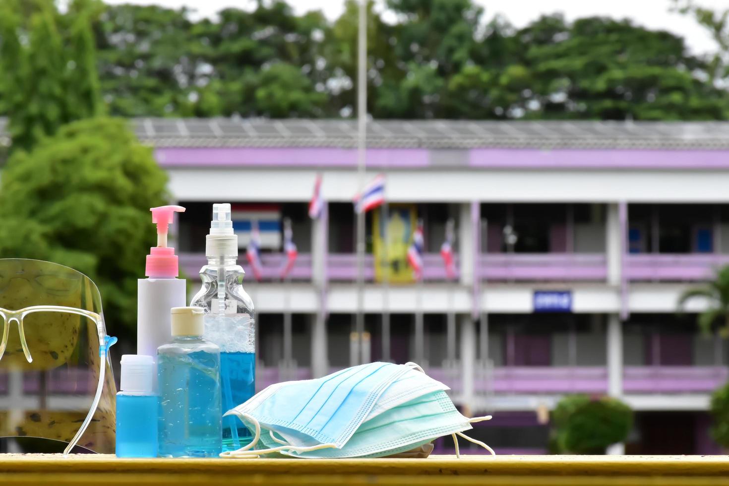 Hand sanitizer gel and facemasks to clean hands and wear before getting inside to protect and prevent Covid-19 virus or Coronavirus and germs. photo