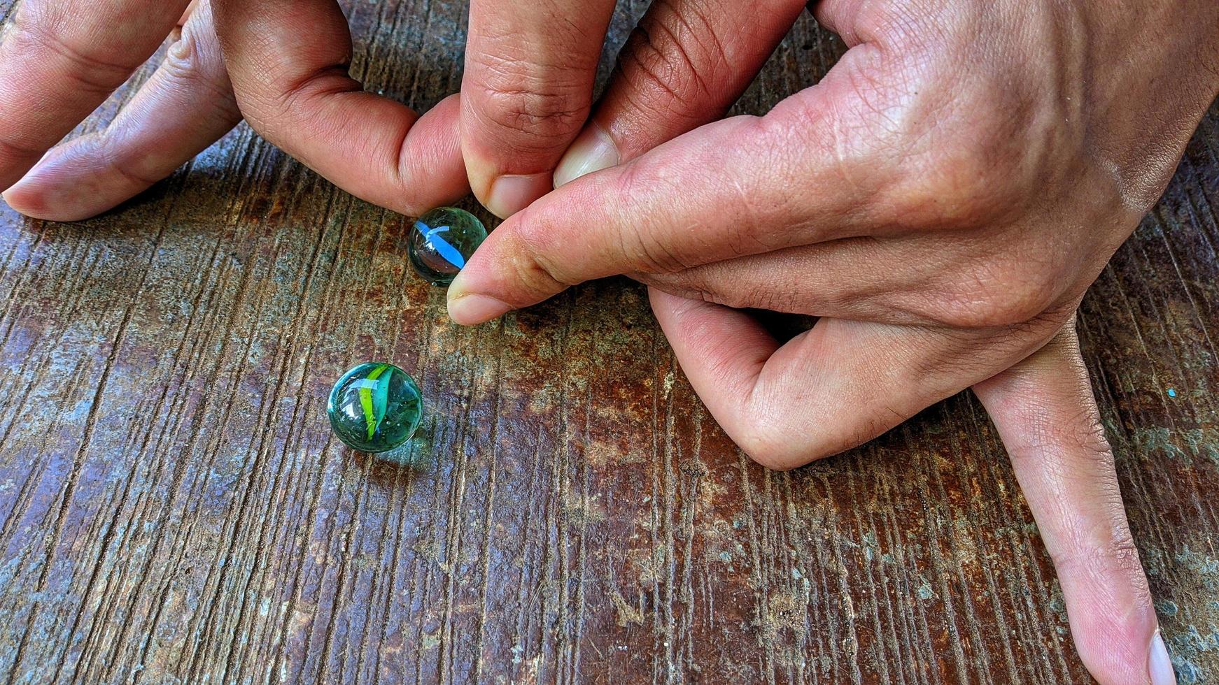 Cianjur Regency, West Java Indonesia, on April 05, 2022 - How to play marbles the Indonesian people. photo