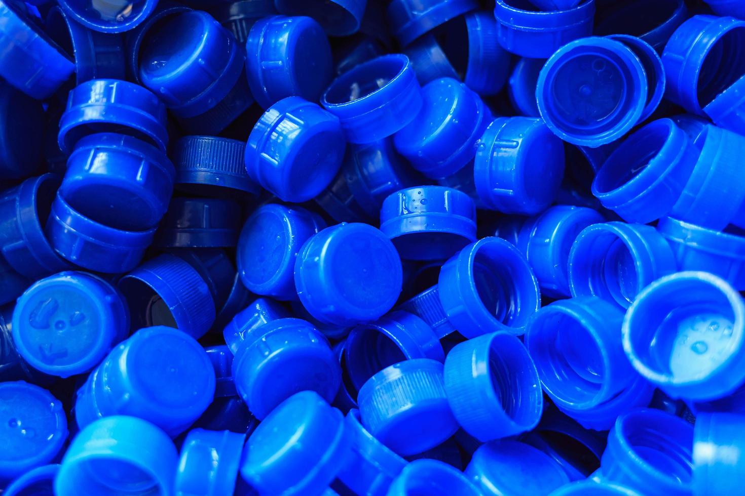 Blue plastic caps used to seal beverage bottles. photo