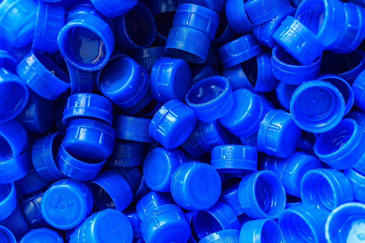 Blue plastic caps used to seal beverage bottles. photo