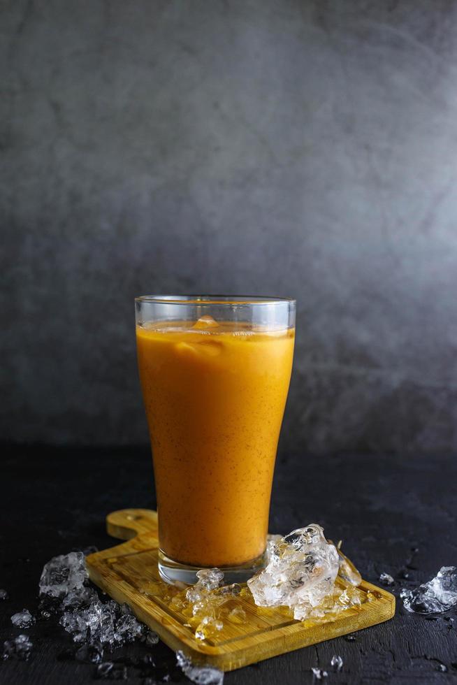 Iced milk tea in a glass with iceIced milk tea in a glass with ice photo