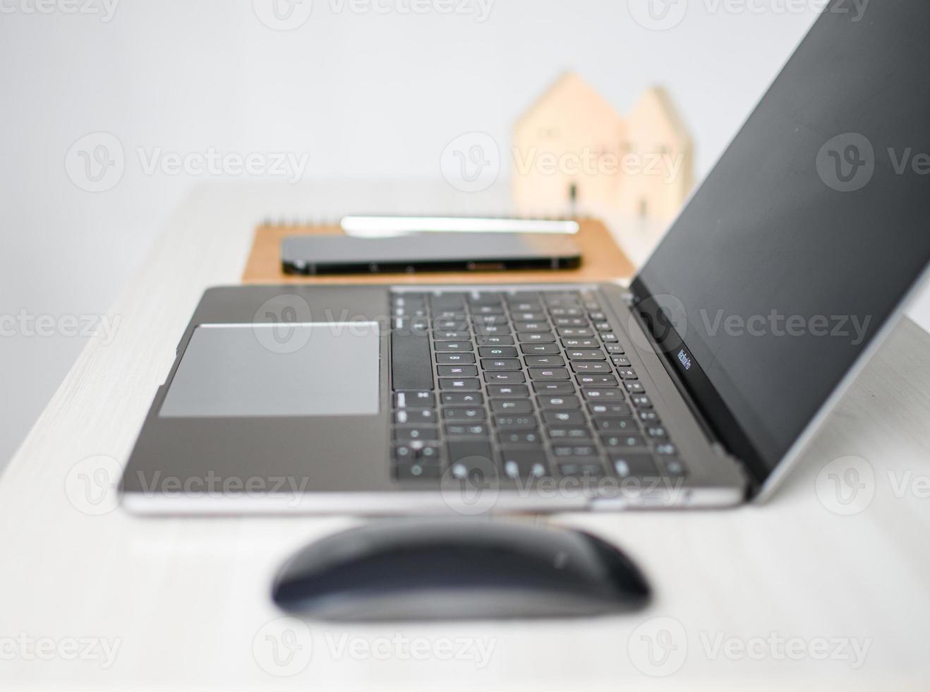 Apple MacBook Pro 13 space grey is power off on desk in the room, save energy Close up. Selective focus. Blurred white background photo