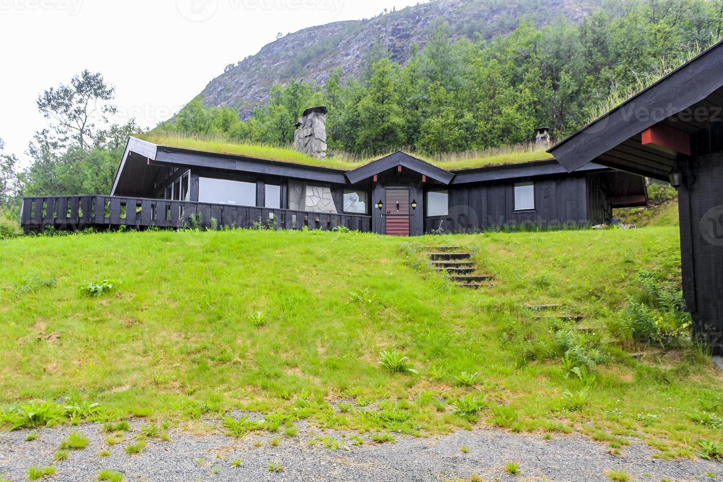 Black wooden cabin hut with overgrown roof in Hemsedal, Norway. photo