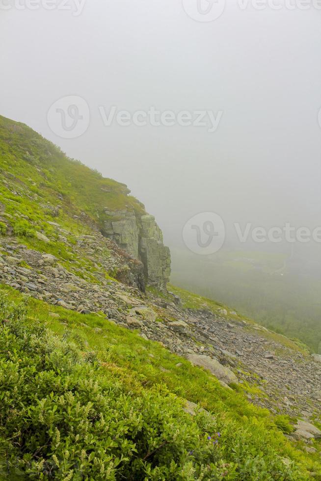 Fog, clouds, rocks and cliffs on Veslehodn Veslehorn mountain, Norway. photo