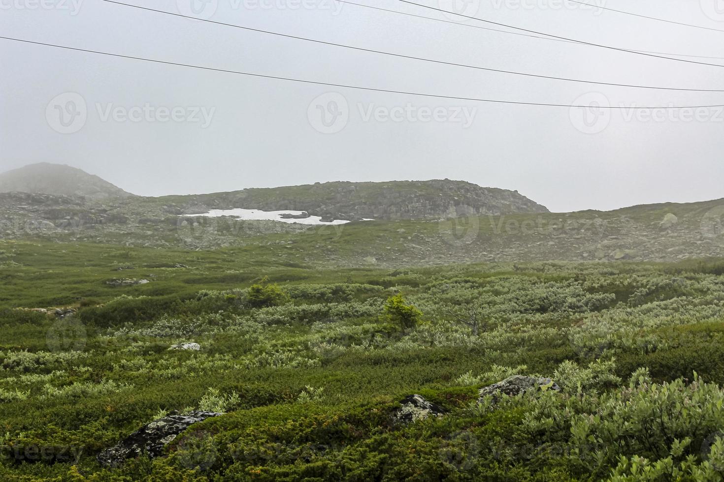 Fog, clouds, rocks and cliffs on Veslehodn Veslehorn mountain, Norway. photo