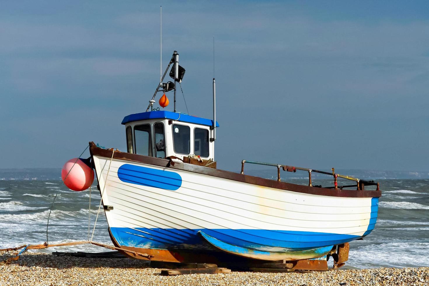 DUNGENESS, KENT, UK, 2008. Fishing boat on the beach photo