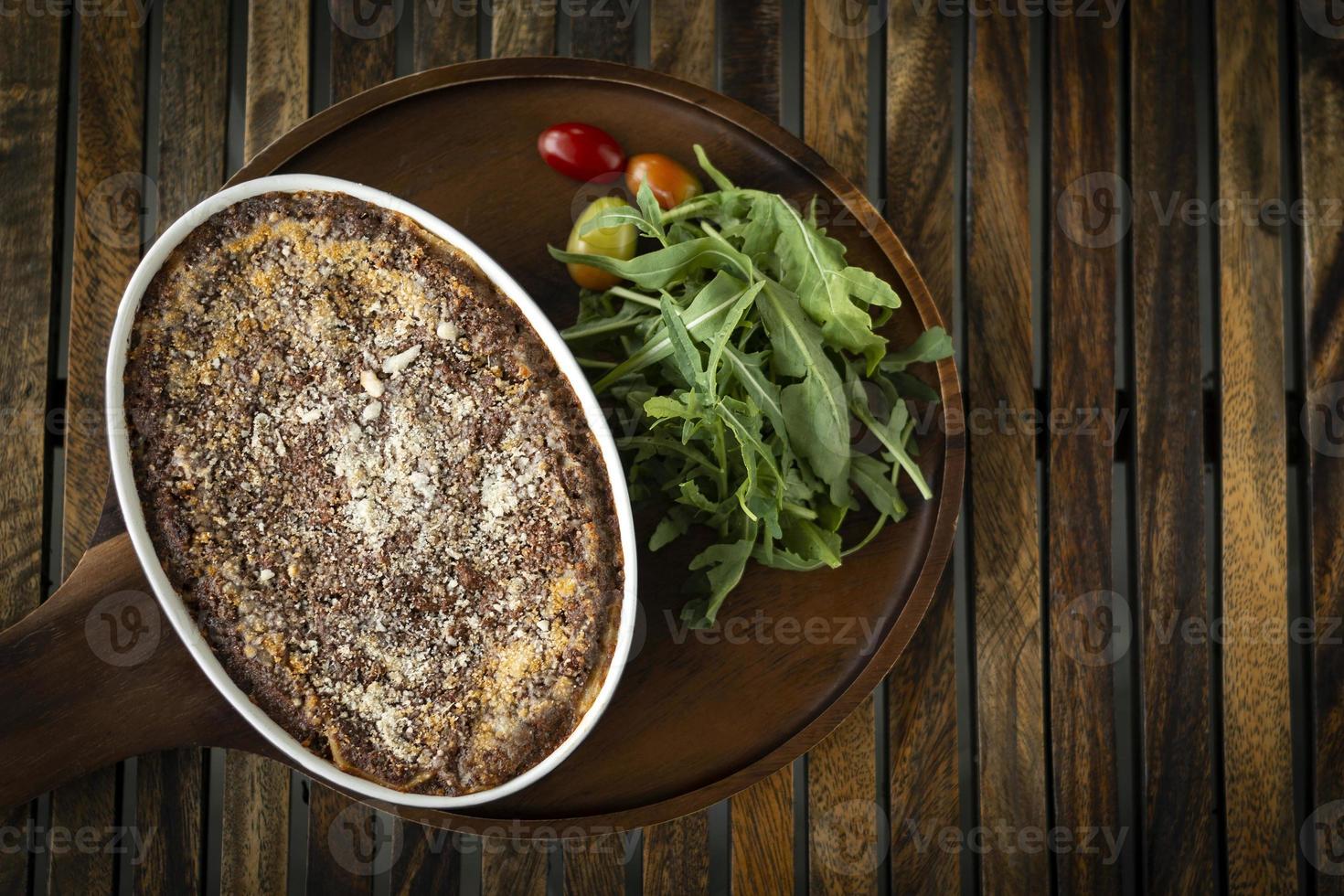 fresh beef lasagna in oven dish on table in rome italy restaurant photo