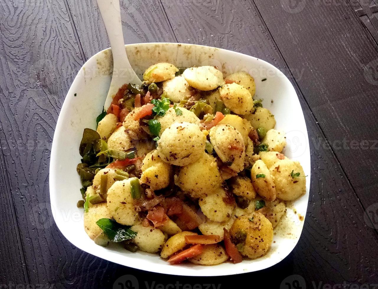 Making rava idli or rava idly is a popular South Indian breakfast dish. cooking Idly in a traditional pot in Kerala India Kitchen. Steamed food. dish made from semolina dushera diwali photo